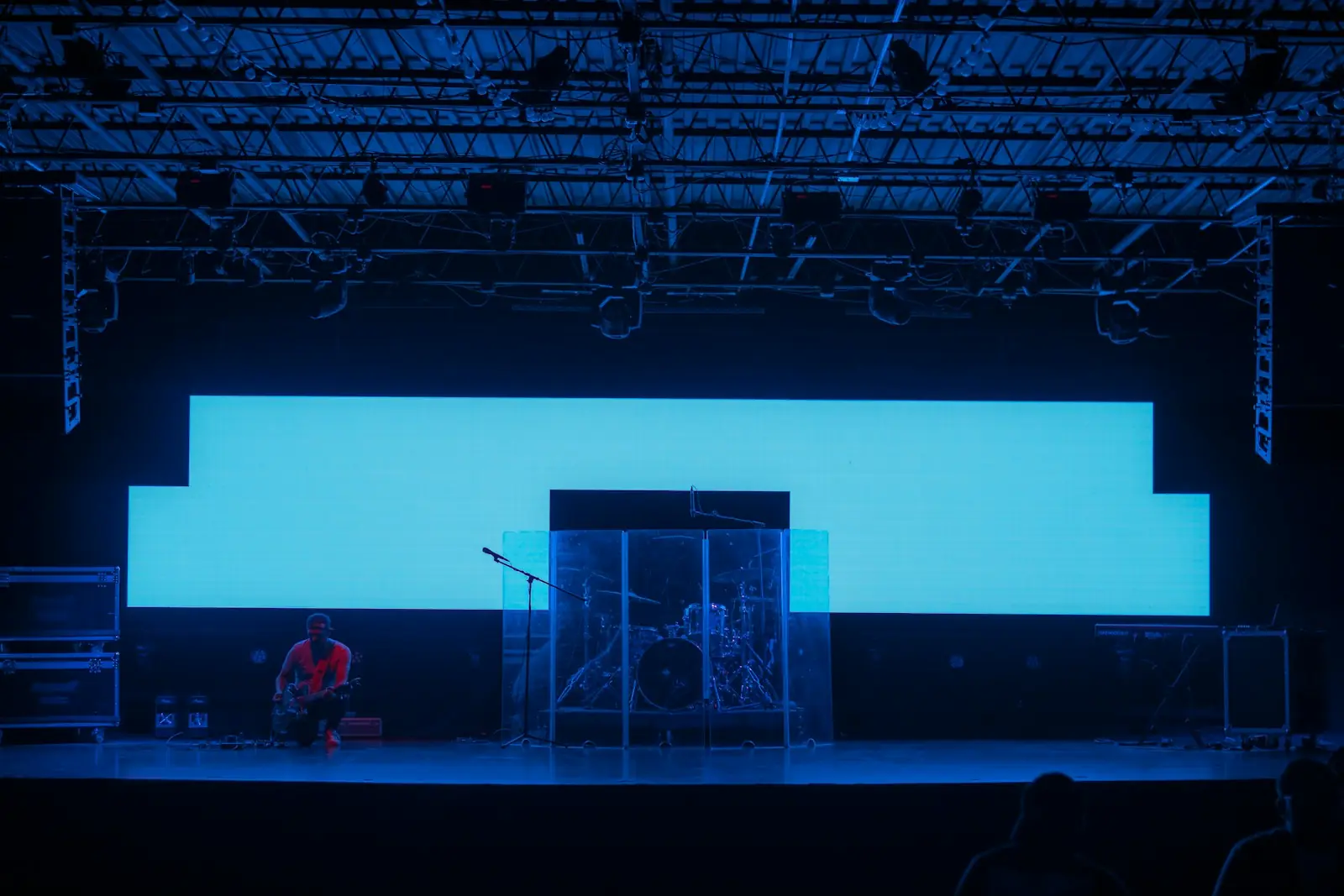 LED video wall installed across a stage with a technician on a ladder